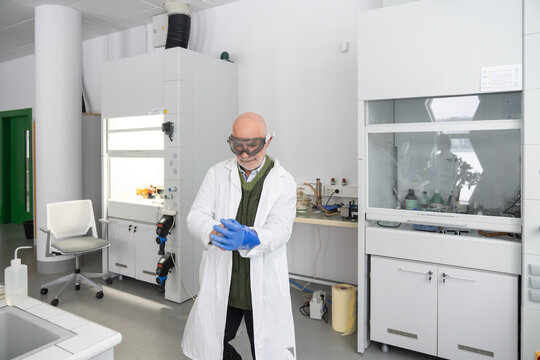 Senior Researcher Put On Gloves In The Laboratory