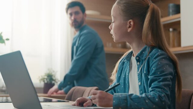 Family at home man daddy busy at kitchen little daughter kid child girl write task homework schoolgirl problem trouble education father help e-learning laptop computer helping with difficult question