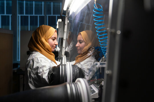 Researcher Wearing Hijab Using The Glovebox