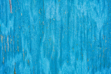 Texture of an old sheet of plywood covered with blue paint.