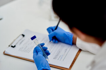 Science, clipboard and lab with test tube in hand, medic and microbiologist with research for...