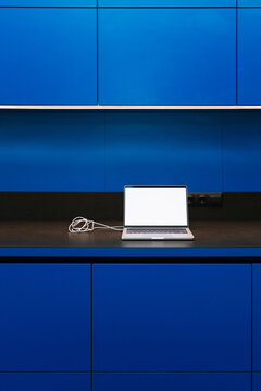 A laptop with white screen in the kitchen