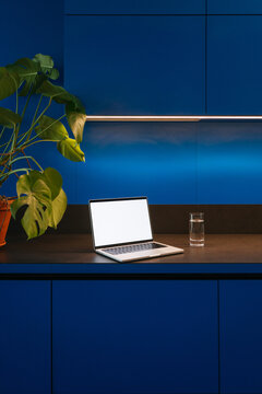 A laptop with white screen in the kitchen