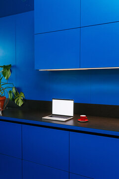 A laptop with white screen in the kitchen