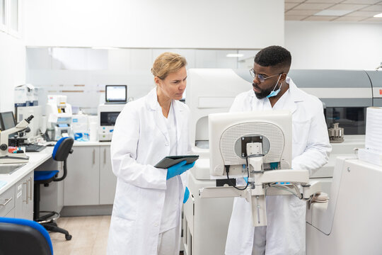 Team of Research Scientists Working On Computer