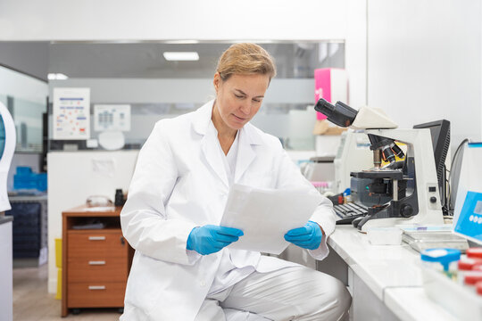 scientist looking at report in a laboratory