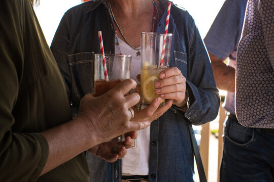 People drinking alcohol at bar during daytime