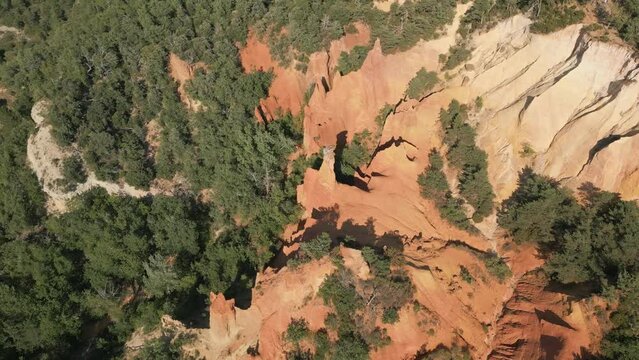 Aerial footage of Red sands and abstract Rustrel canyon moher cliffs landscape. Provencal Colorado near Roussillon,in the Vaucluse department - Southern France.