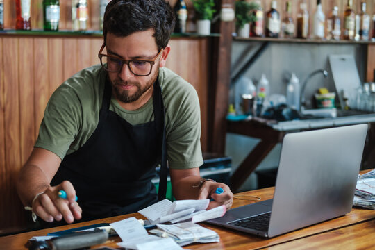 working with receipts and a computer doing financial work