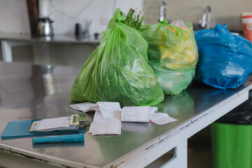 Restaurant kitchen table with grocery bags and their receipts
