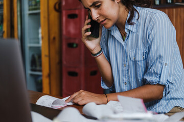 frustrated businesswoman with a messy  workspace with many receipts