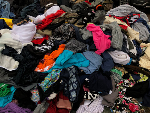 Pile of Assorted Clothing at Outdoor Market