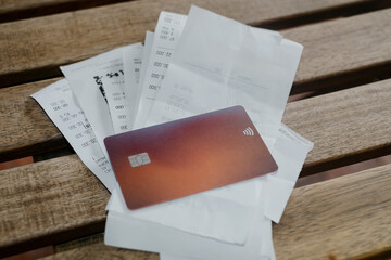 Bunch or receipts on the table with card 