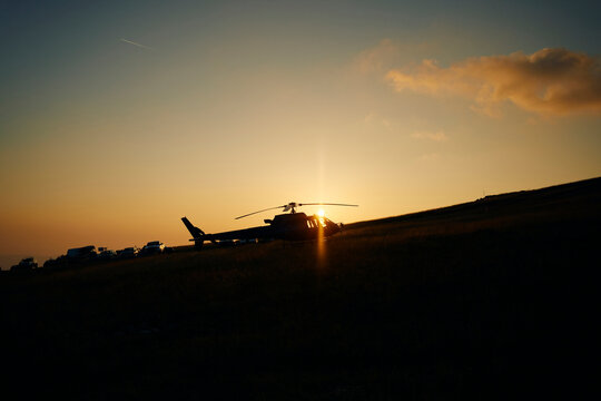Grounded helicopter at sunset