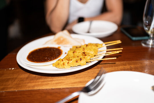Pork satay dish with sauce.