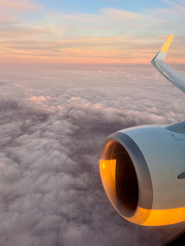Passenger airplane wing and engine at dusk