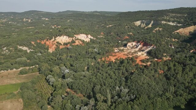 Aerial footage of Red sands and abstract Rustrel canyon moher cliffs landscape. Provencal Colorado near Roussillon,in the Vaucluse department - Southern France.
