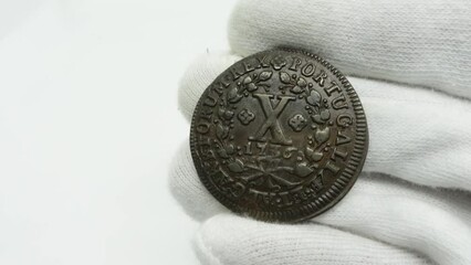 Portuguese copper coin of King João V. Obverse and reverse of the X Reis coin. On the obverse the coat of arms. On the reverse the value of the coin and the year 1736