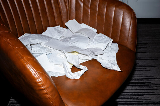Messy receipts on a leather office chair