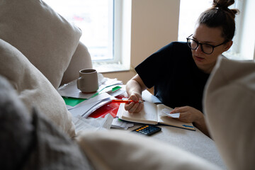 woman reviewing, organizing receipts, invoices, filling out tax forms