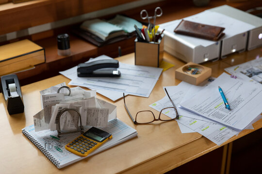 Home office desk with receipts and paperwork 