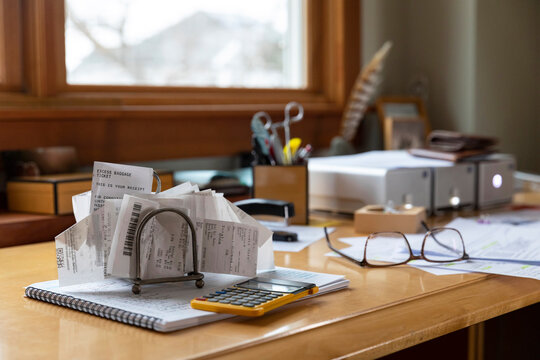 Receipts in paper holder rack at home office 
