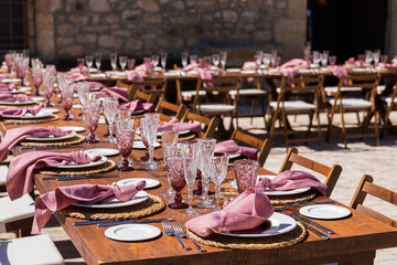 A wedding setup of a table filled with elegant glasses and cups