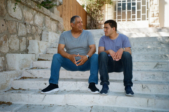 Father and Son Sharing a Moment on City Steps.