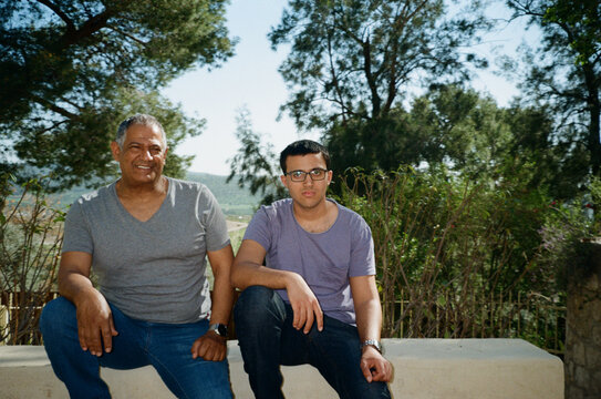 Outdoor Portrait of Smiling Father and Son.