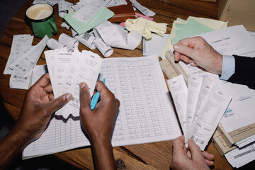 Hands Organising Receipts and Ledger
