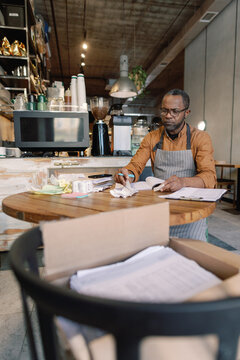 Barista immersed in finances 
