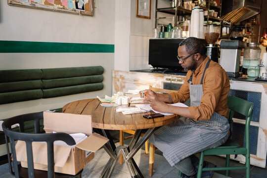 Cafe owner arranging papers

