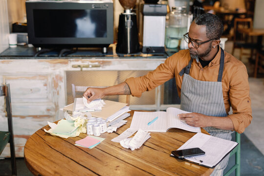 Barista sorting receipts 
