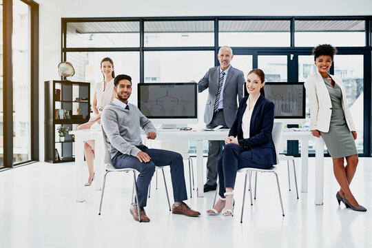Portrait, computer and employees in office together, coworking or workspace for career in data analyst or desk. Online, statistics for digital stock for business, website or analytic spreadsheet