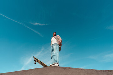 Skateboarder standing on ramp with copyspace
