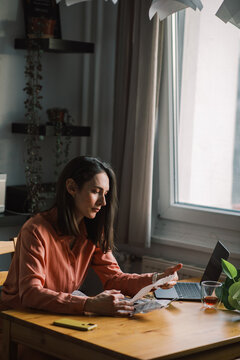 Woman Calculating Costs and Budgeting
