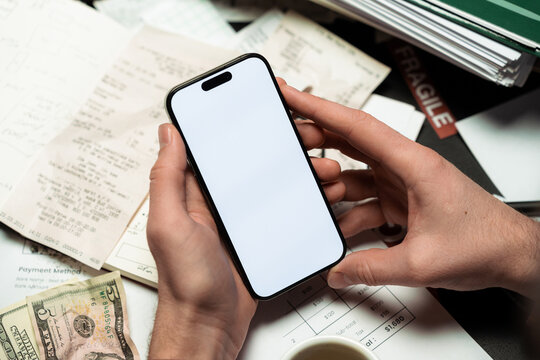 Men hands with a mobile phone with white screen in the office