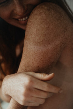Close Up woman's skin texture of Ginger female with many freckles 