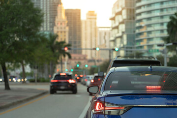 American street with driving cars at intersection with traffic lights in Miami, Florida. USA transportation