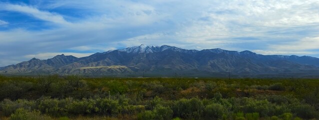 Fototapeta premium Snow tipped Arizona mountains in a rural valley wilderness
