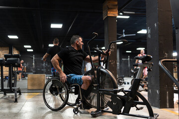 Smiling man in wheelchair working out at the gym