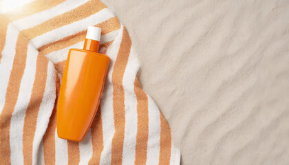 UV protection on the beach concept. Top view photo of of orange sunscreen bottle and striped towel on the sand on isolated background with copyspace
