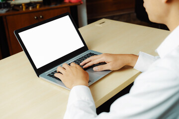 Business person or office worker using laptop computer while sitting at desk. uds
