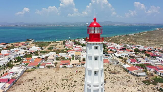 An aerial view of the Ilha do Farol lighthouse located in the Algarve tourist region on Portugal's southern coast. View of the Ria Formosa and the town of Olhao.