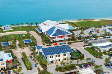 Photovoltaic panels for producing clean ecological electric energy. Florida office buildings with solar roofs. Renewable electricity with zero emission concept