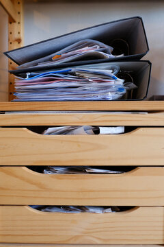 Business receipts in messy cabinet and folder
