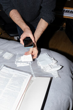 Man scanning receipts with smartphone for his business accountability