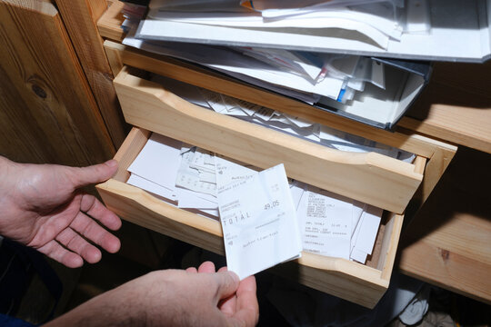 Man organizing receipts for his business accountability