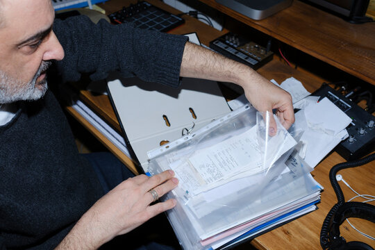 Man organizing receipts for his business accountability