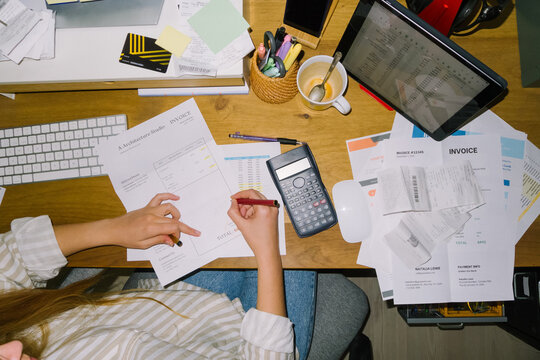 Top view of a woman doing taxes